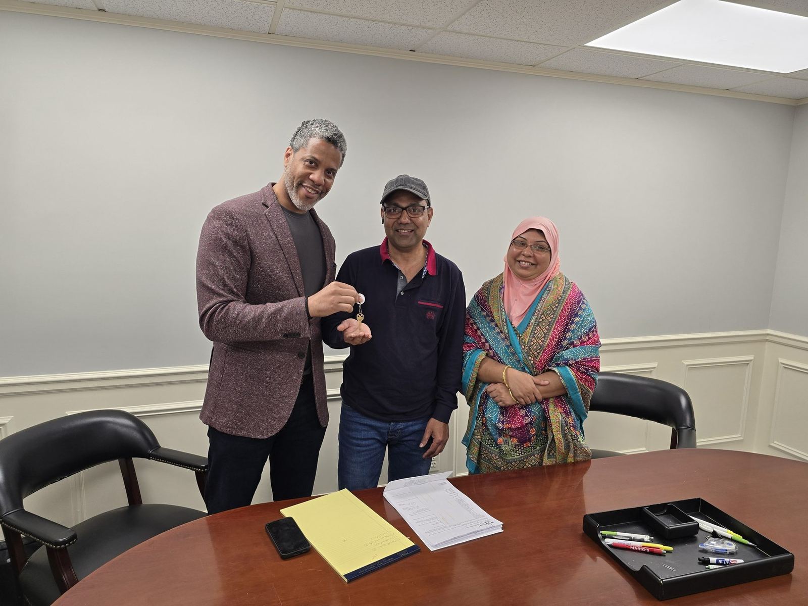 Diallo J. Stevens with two of his clients at their closing