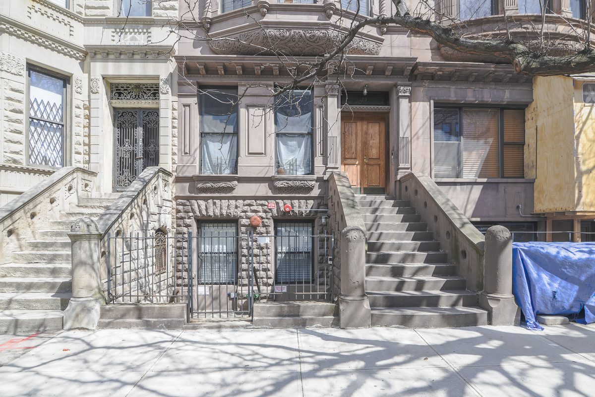 A brownstone stoop and parlor-floor entrance, with the garden-level entrance beneath