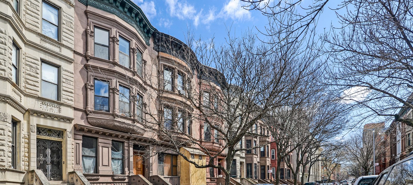 A tree-lined row of brownstones in Harlem&rsquo;s Mount Morris Park Historic District