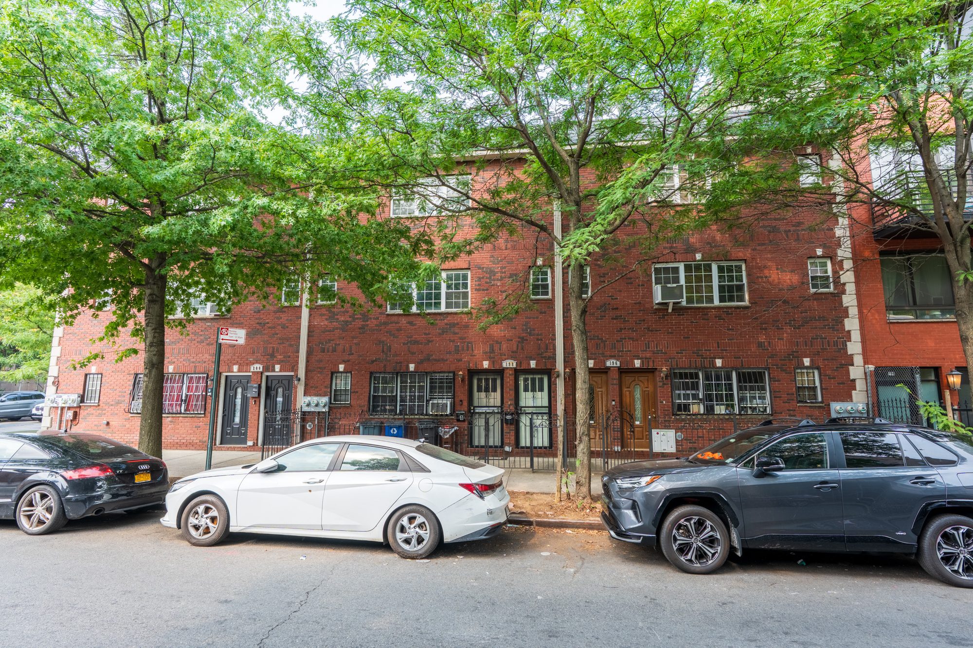 Brick row houses on a tree-lined Brooklyn street